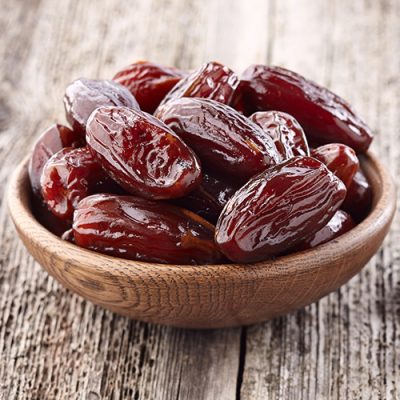 62513707 - dates fruit on a wooden background